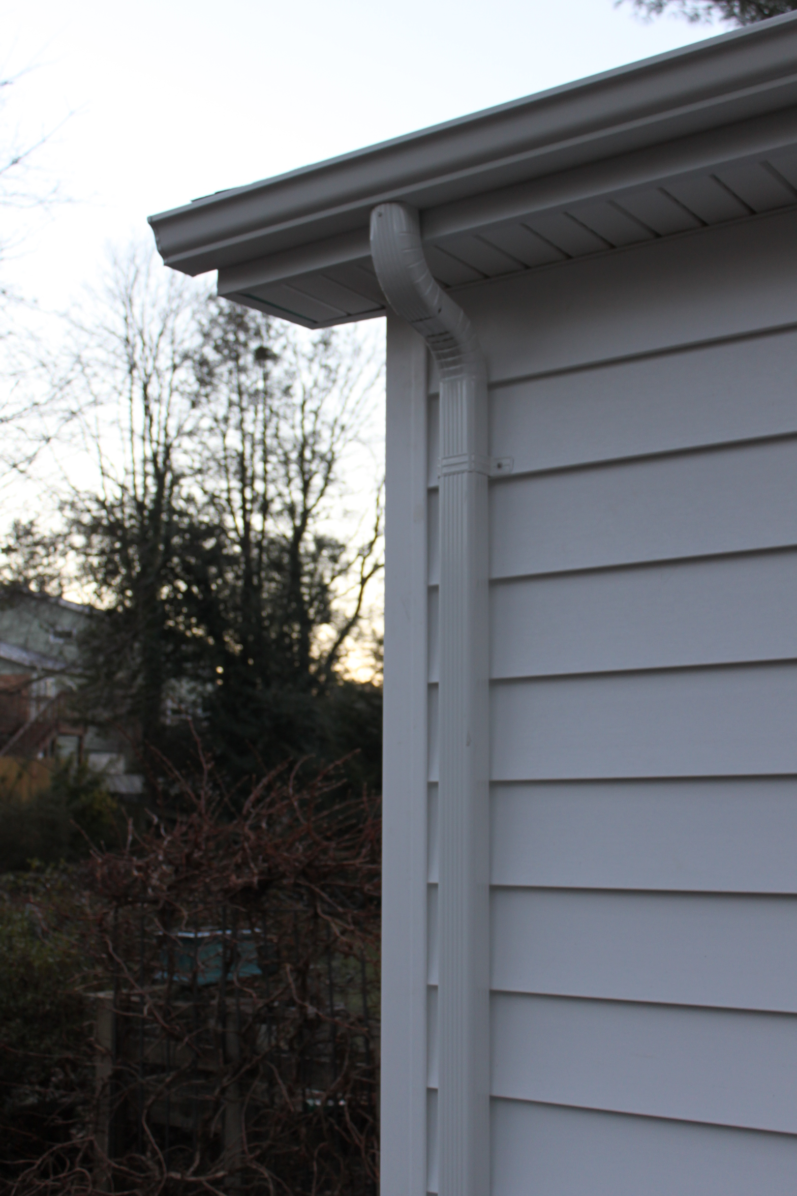 Seamless gutter corner and downspout detail on a Sunshine Contracting installation