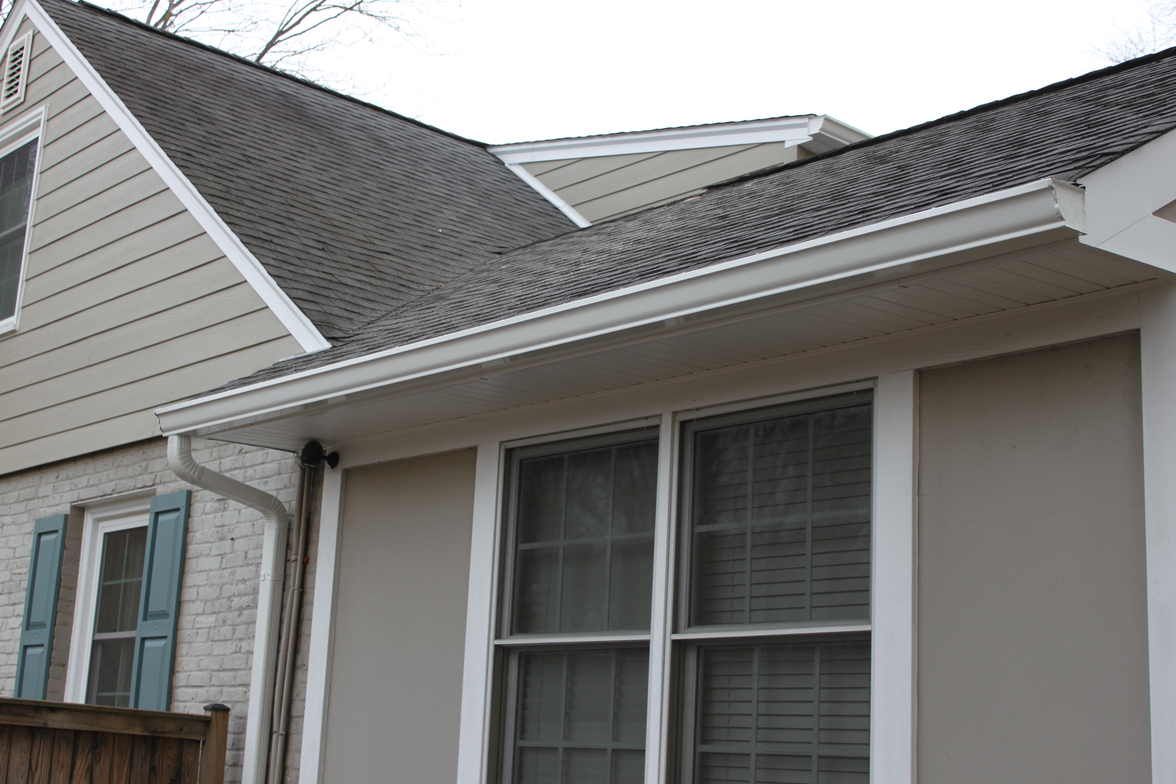 New white seamless gutters and soffit installed by Sunshine Contracting