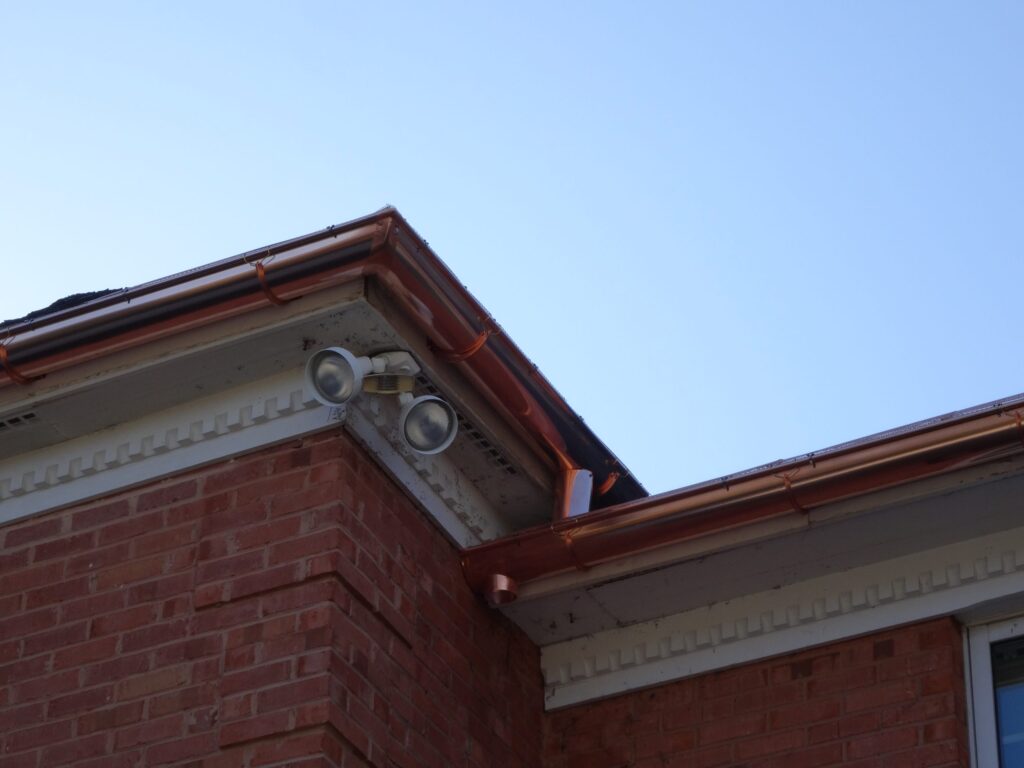 Copper gutter and downspout at a corner return