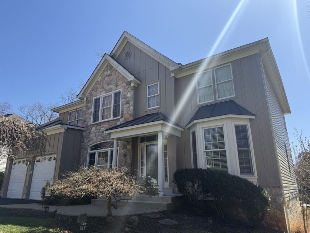 Annandale, VA home after stucco was replaced with James Hardie board and batten siding in Khaki Brown