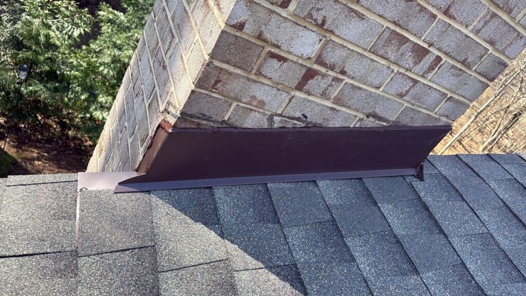 New roof flashing where the roof meets a brick chimney in Annandale, VA