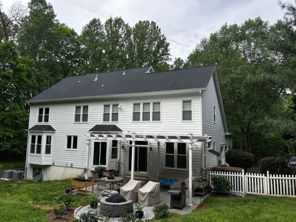 Back of a Fairfax, VA home with new white James Hardie siding and bay windows