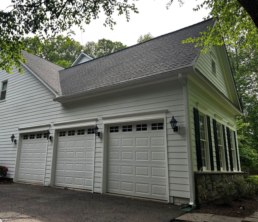 Three-car garage side of a Fairfax, VA home in new white James Hardie siding