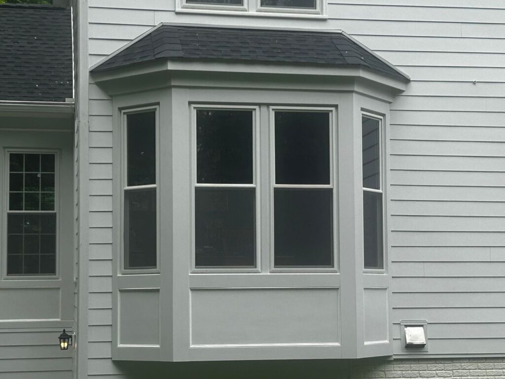New James Hardie siding and white trim around a bay window on a Fairfax, VA home