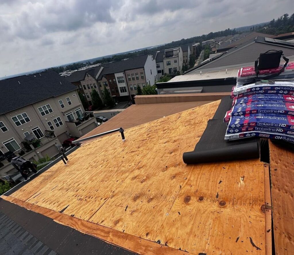 Old roof removed down to the decking on an Ashburn, VA townhouse, with GAF Timberline HDZ bundles ready