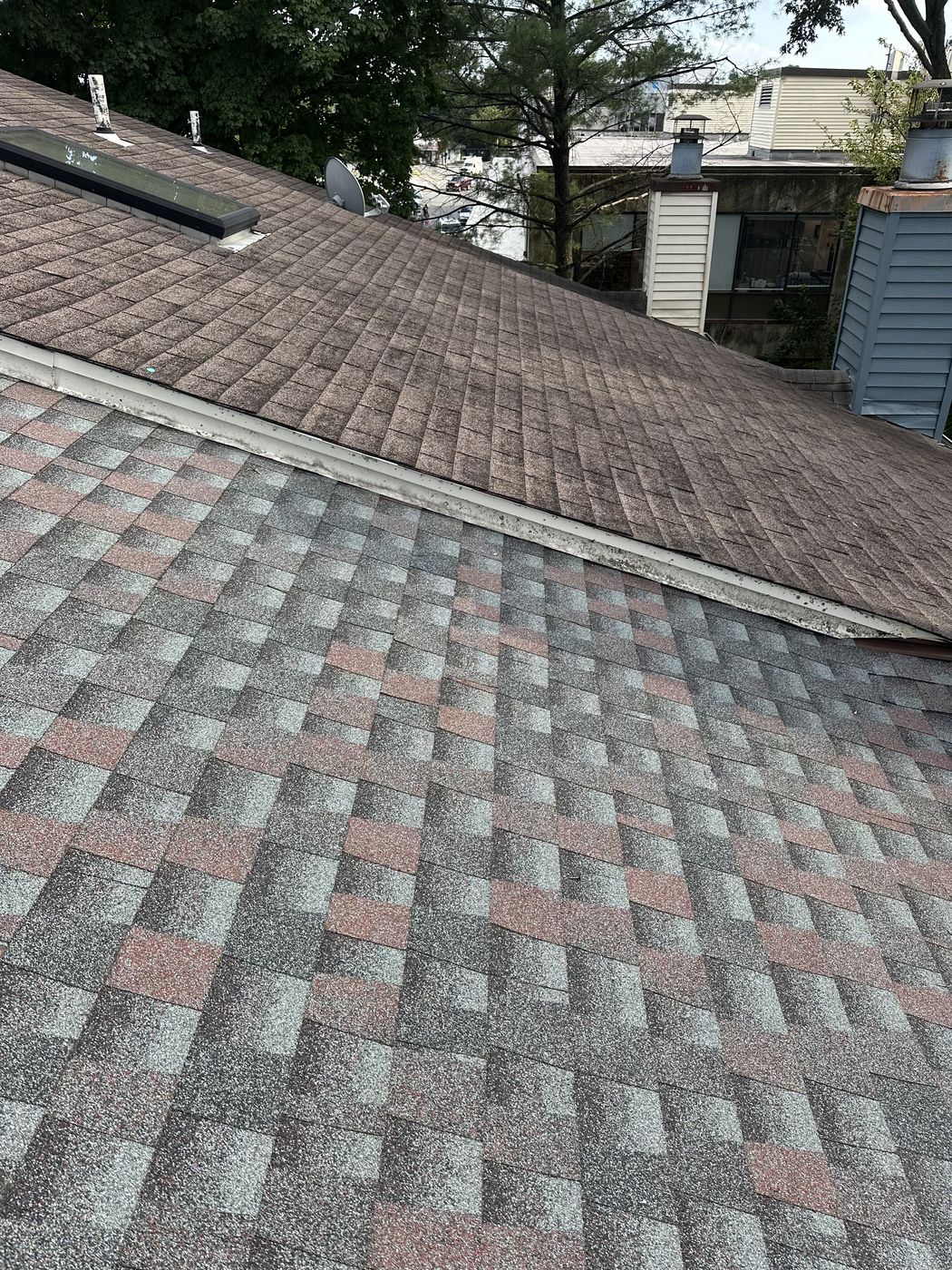 New GAF architectural roof in Alexandria, VA beside an older neighboring roof