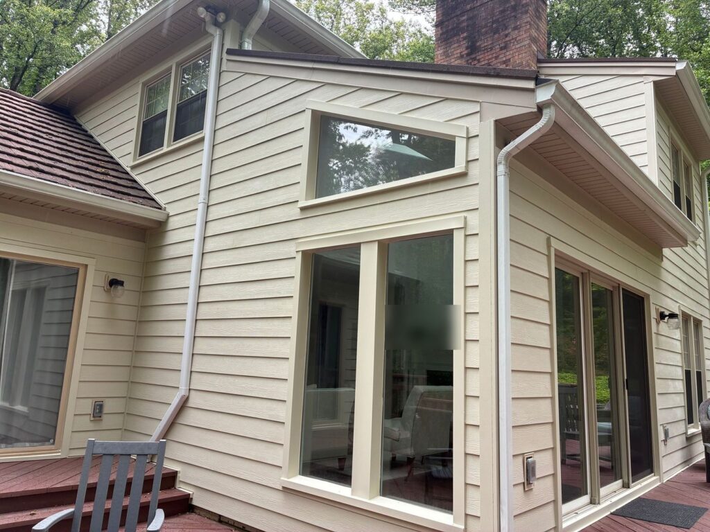 New James Hardie siding and trim around large rear windows in Fairfax Station, VA