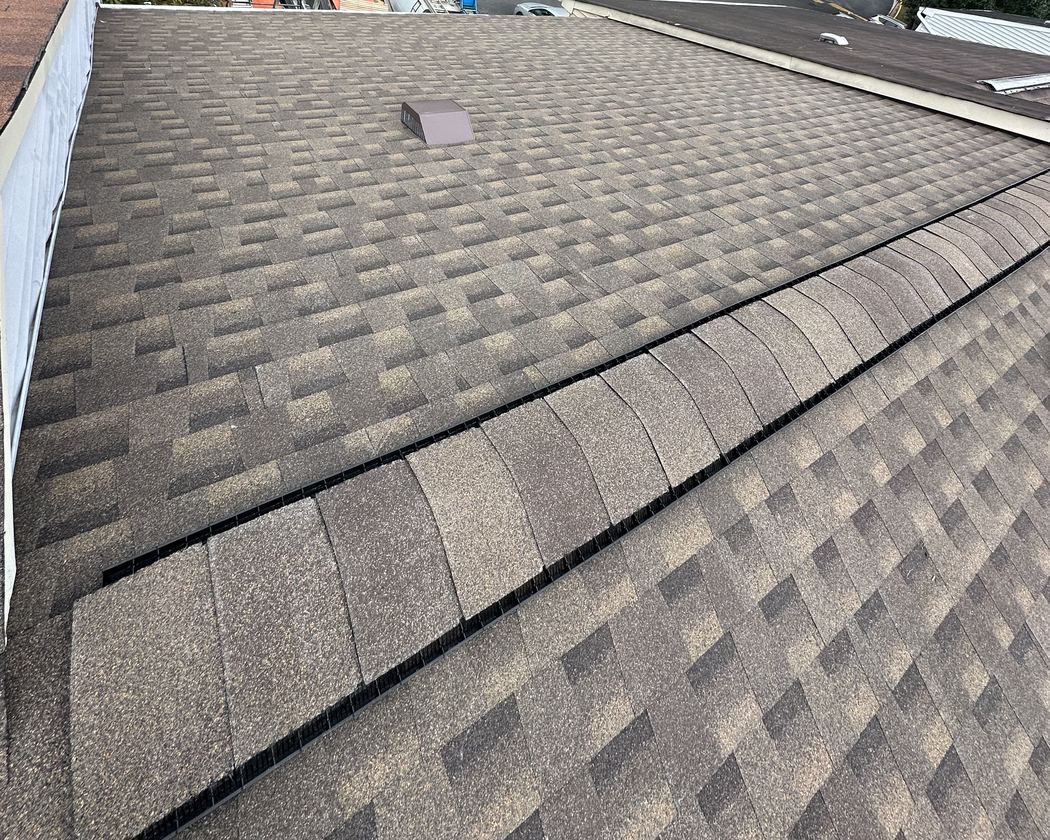 New GAF architectural shingles and ridge cap on a Lorton, VA townhouse roof