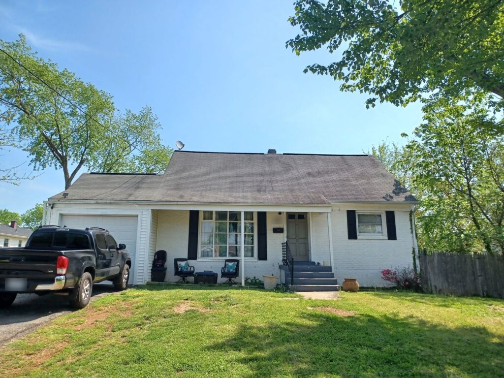 Manassas, VA home before its roof replacement, with the old worn shingles