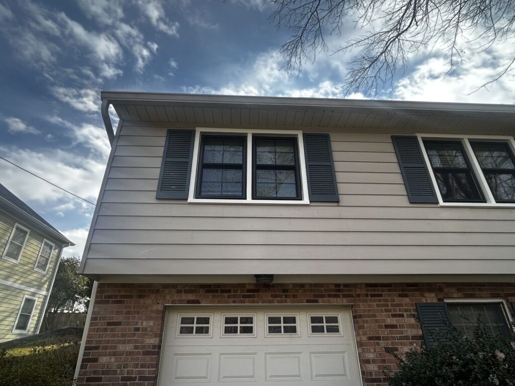 New ProVia replacement windows with black exterior frames and shutters on a McLean, VA home