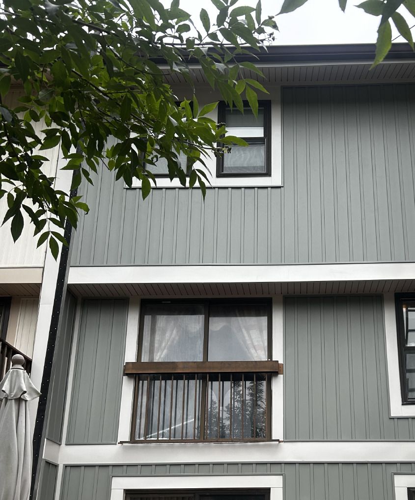 Back of a Burke, VA townhouse after new gray board and batten vinyl siding with white trim