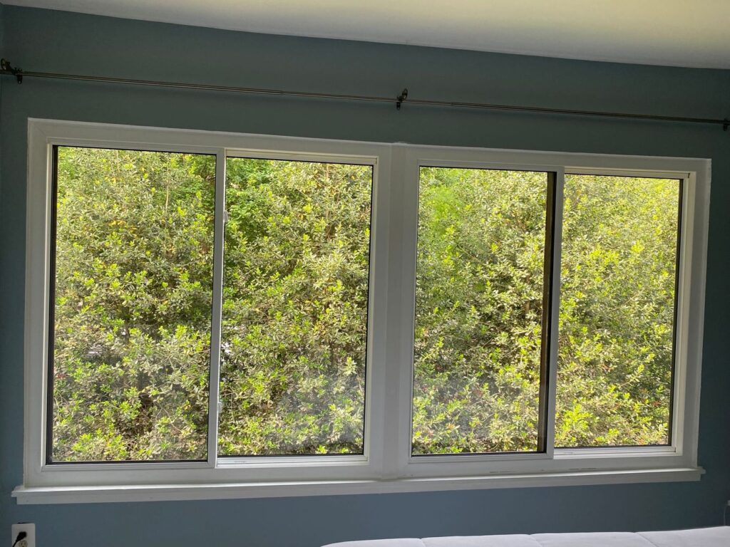 A pair of new Sunrise sliding windows with white interior frames in a Reston, VA townhouse