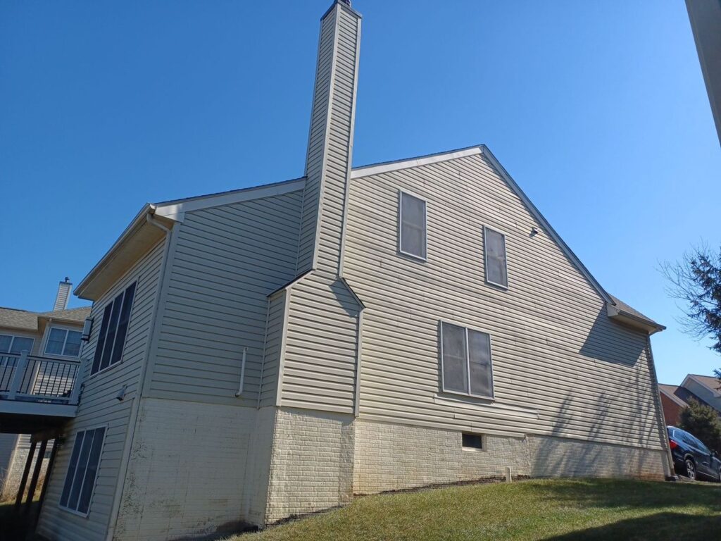 Herndon, VA home before new siding, chimney side with the old vinyl siding