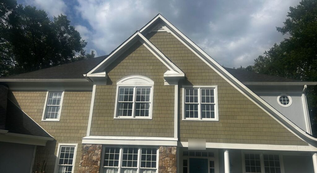 Front gables of a Sterling, VA home in new olive James Hardie shake siding with white trim