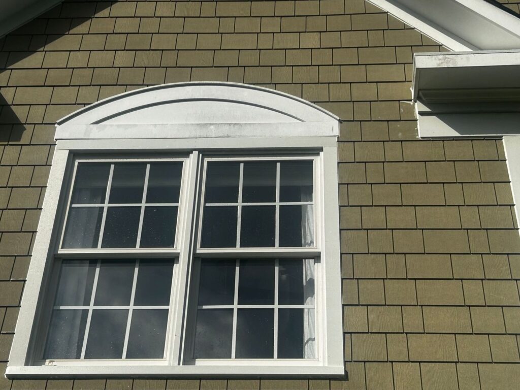 White trim around an arched gable window with James Hardie shake siding in Sterling, VA