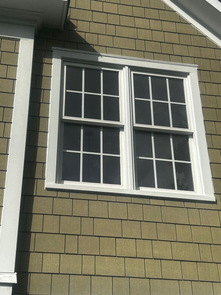 James Hardie shake siding and white trim around a double window in Sterling, VA