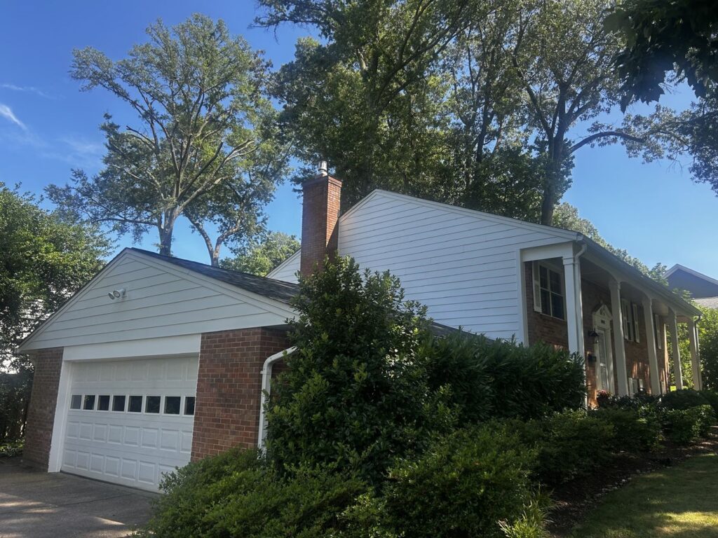 New white James Hardie lap siding on the garage side of an Alexandria, VA home