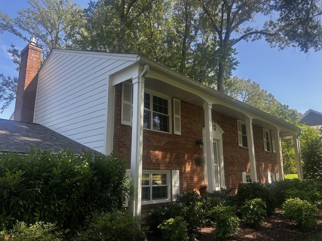 Alexandria, VA home with new James Hardie siding on the upper side wall and the brick front kept