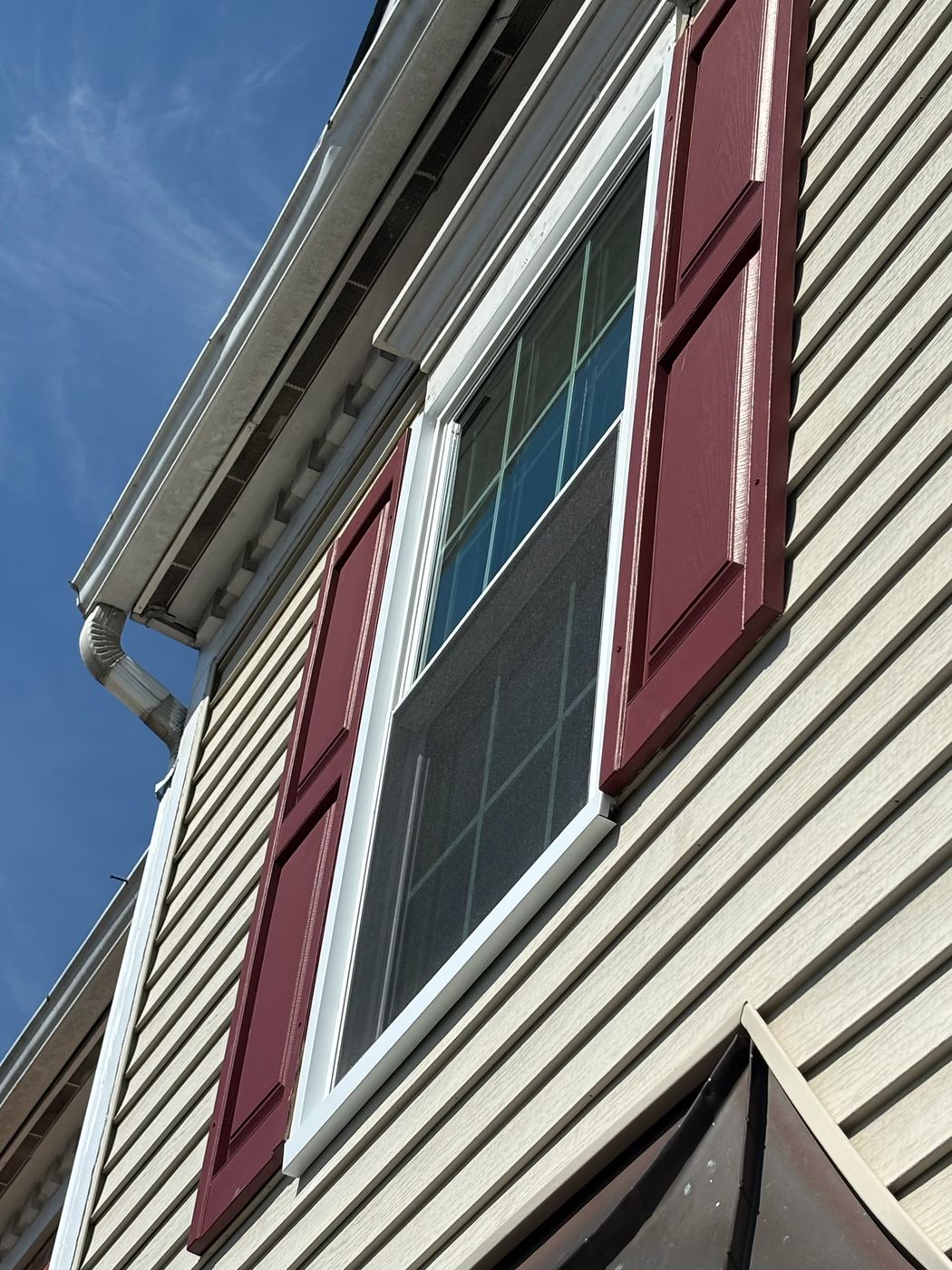 New replacement window with red shutters on a Fairfax, VA home